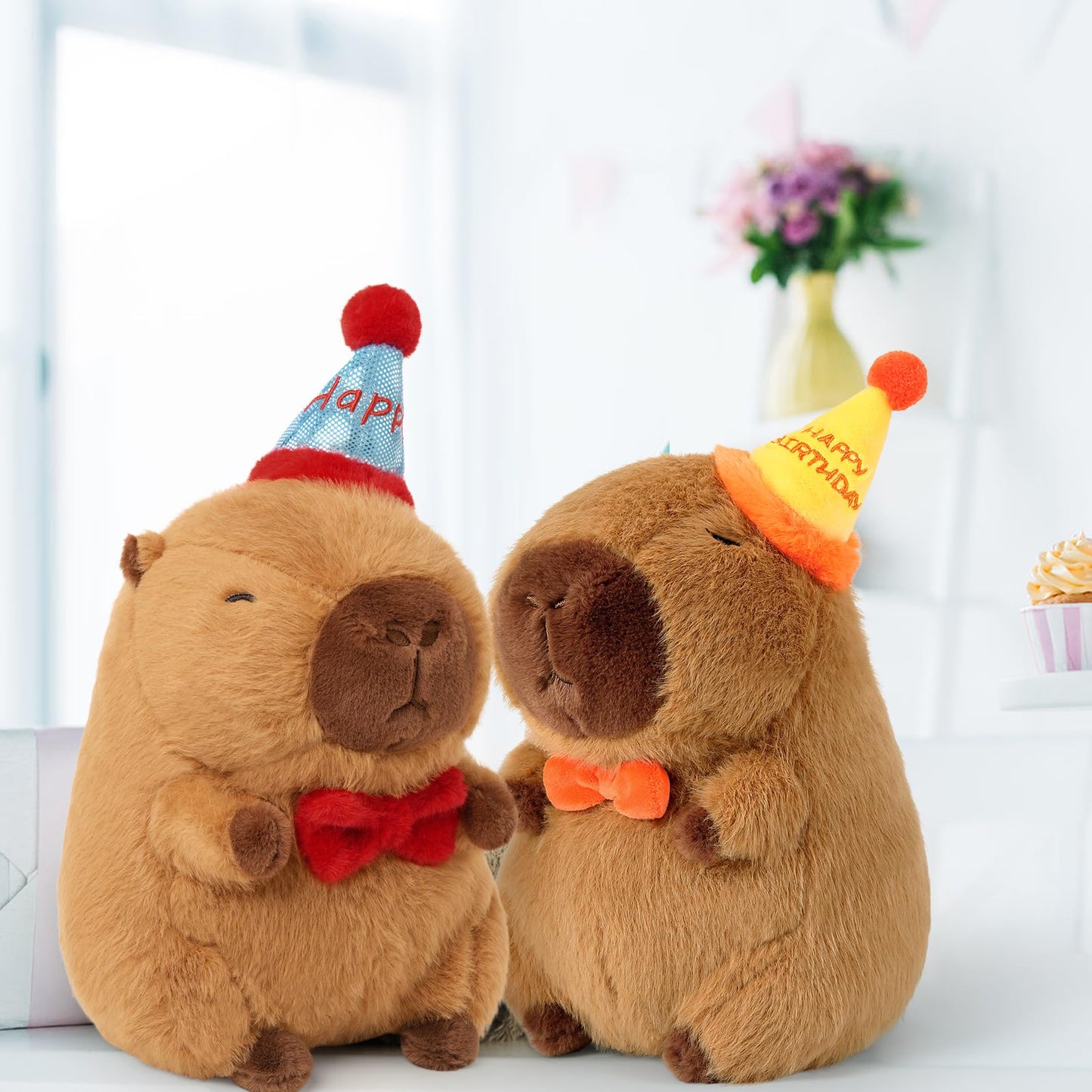 capybara birthday plush pillow set with party hats and bow ties in cozy indoor setting