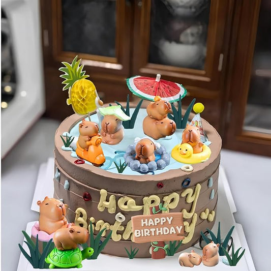 Colorful birthday cake with detailed capybara cake toppers playing in water and holding balloons