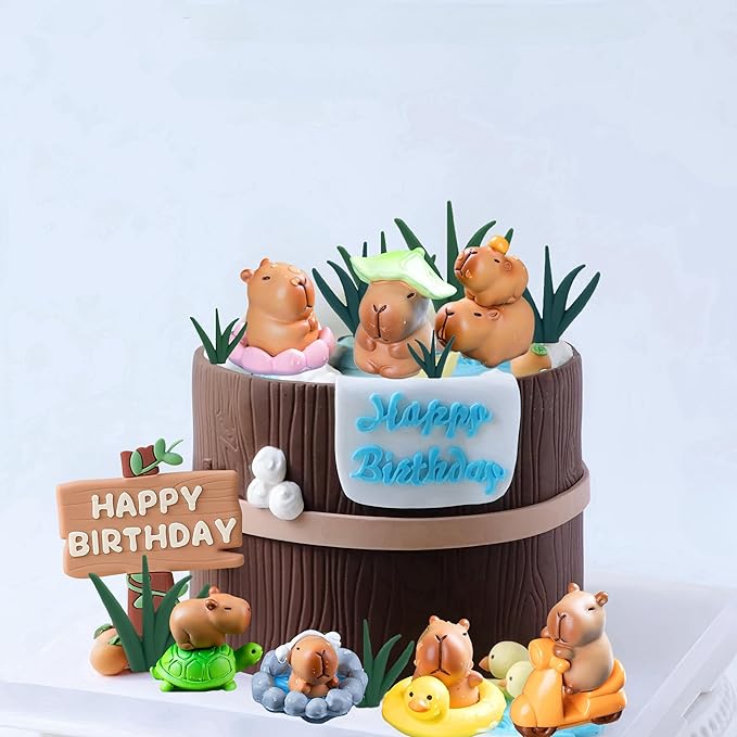 Capybara cake toppers on a brown birthday cake with Happy Birthday sign and various cute capybara figures