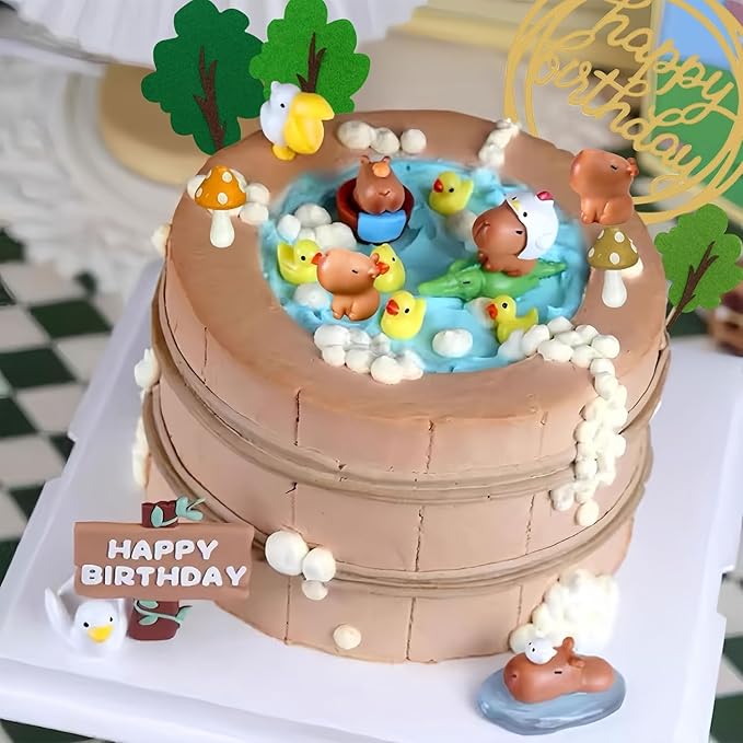Capybara cake toppers set on a two-tier brown cake with pond and duck decorations