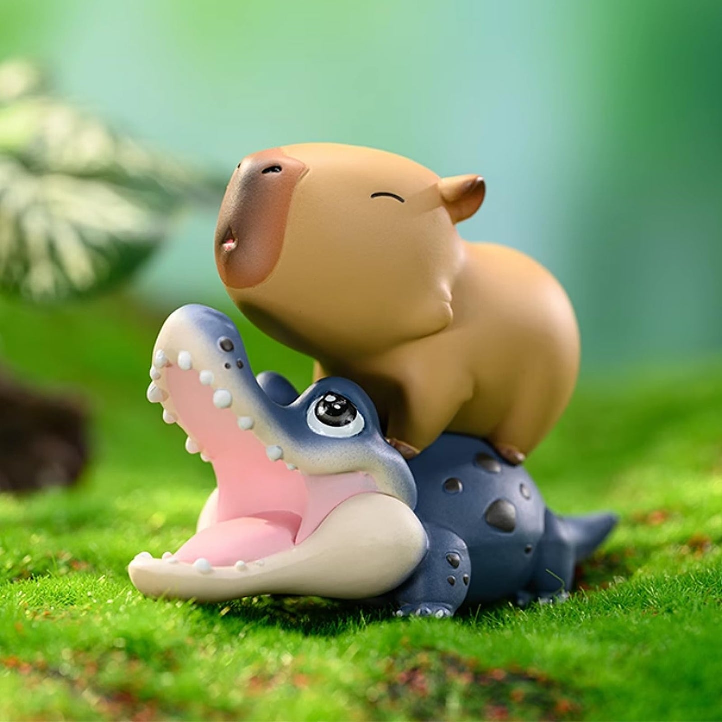 Capybara Cute Cake Toppers featuring a brown capybara sitting on a smiling blue alligator figurine