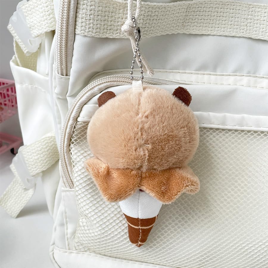 capybara ice cream keychain plush hanging on white backpack with textured pocket