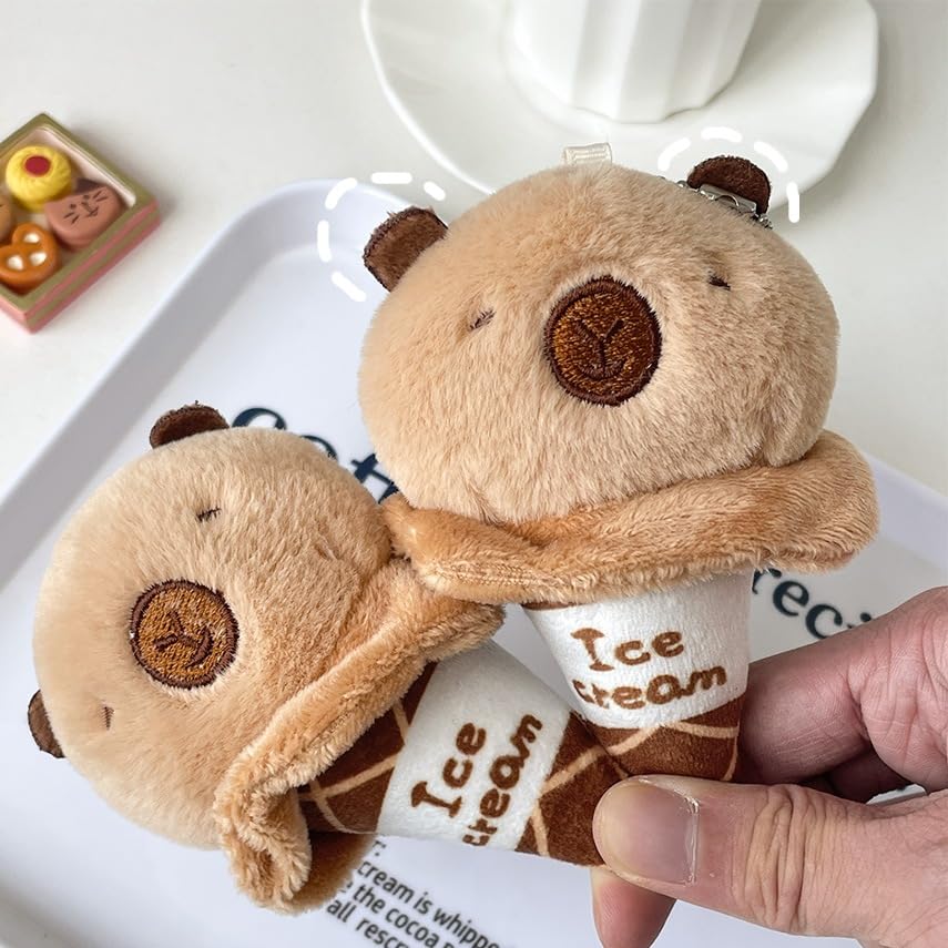 capybara ice cream keychain with plush design and embroidered details held in hand