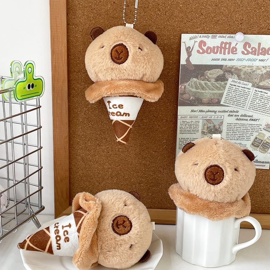 capybara ice cream keychain plush toy hanging and placed on a table with corkboard background