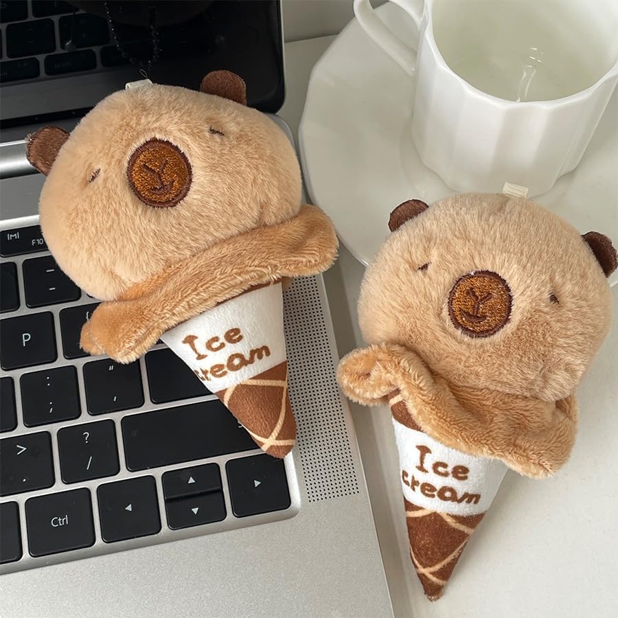 capybara ice cream keychain plush toy with soft brown fur and cone design on laptop and table