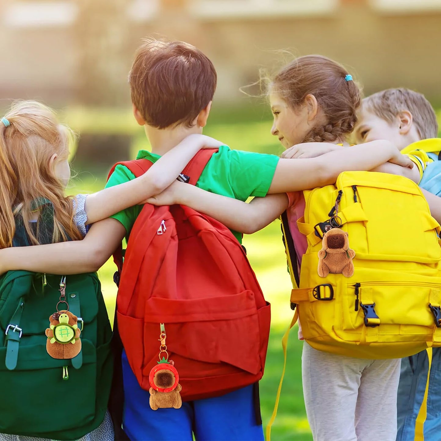 Capybara keychain set attached to colorful kids backpacks during outdoor playtime