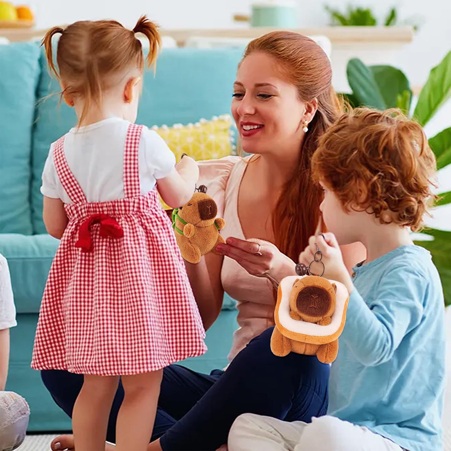 Capybara keychain set held by smiling woman surrounded by happy children in living room