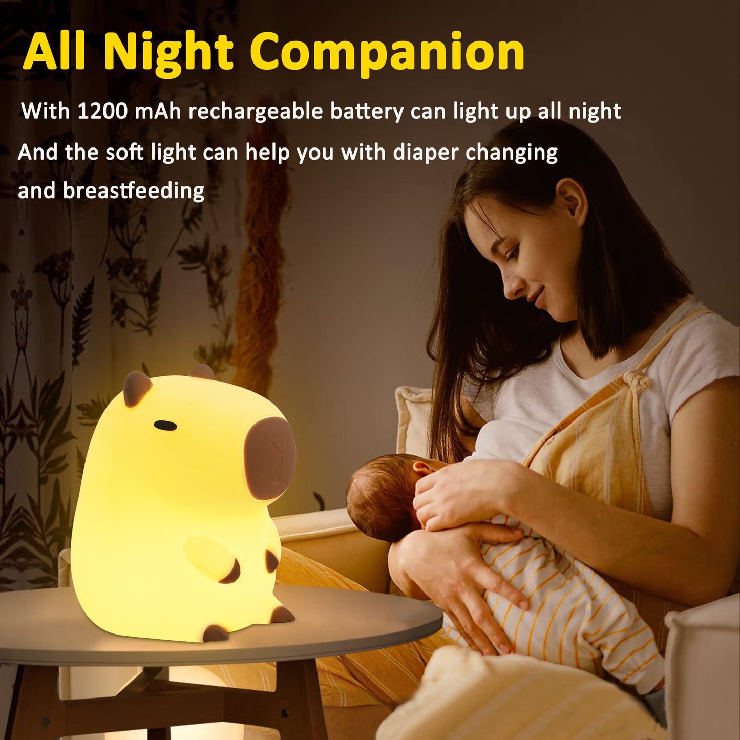capybara night light glowing softly on a table next to a mother breastfeeding her baby