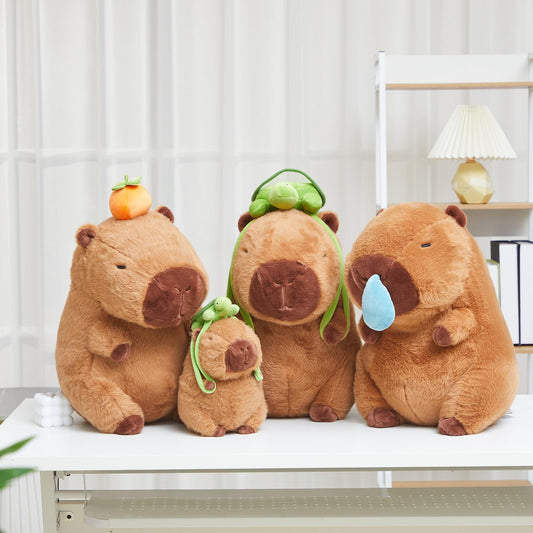 capybara plush toy set featuring two cute brown capybaras, one with a green turtle hat and the other with a blue teardrop accessory