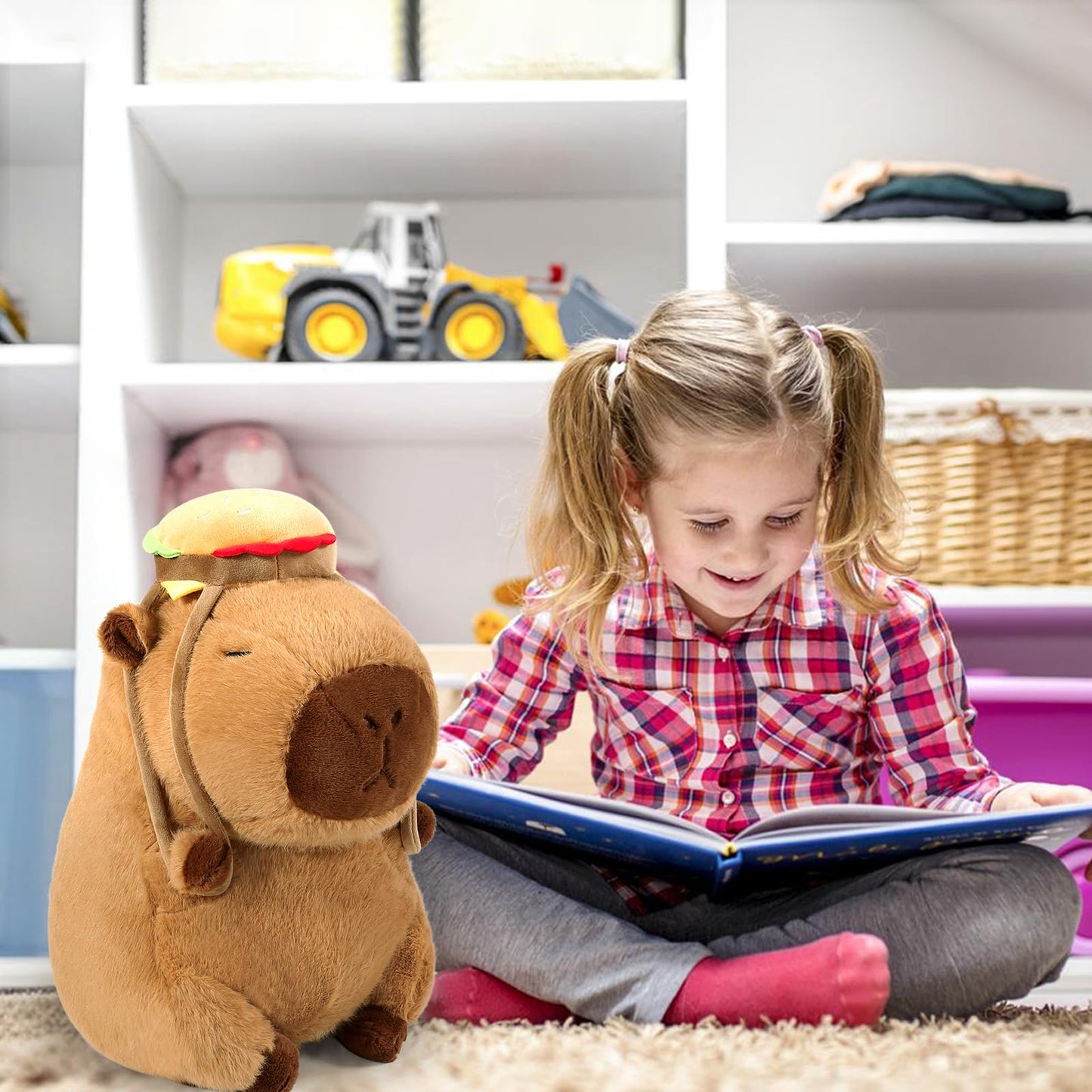 Cute capybara plush toy with hamburger backpack sitting next to a girl reading a book in a playroom