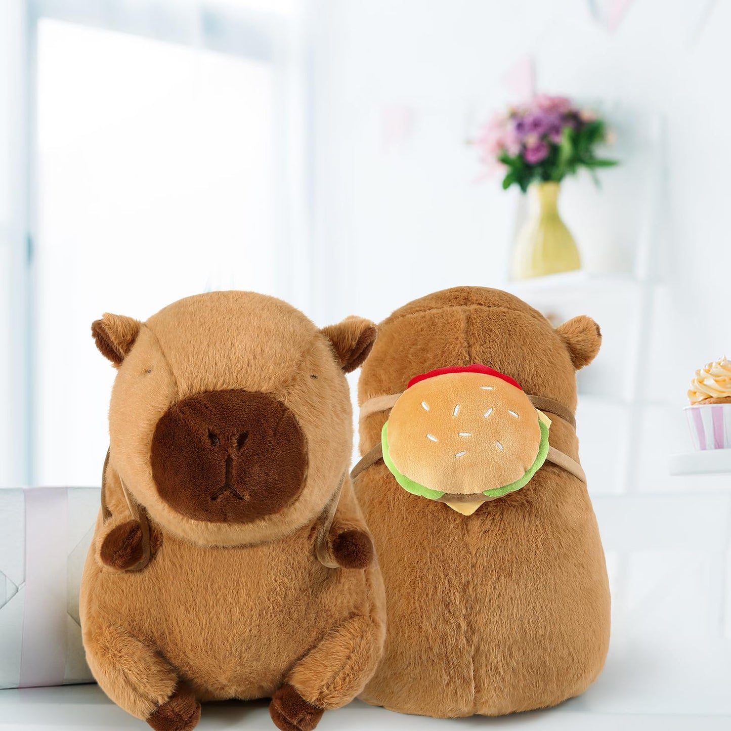 capybara plush toy with hamburger backpack shown from front and back on white surface