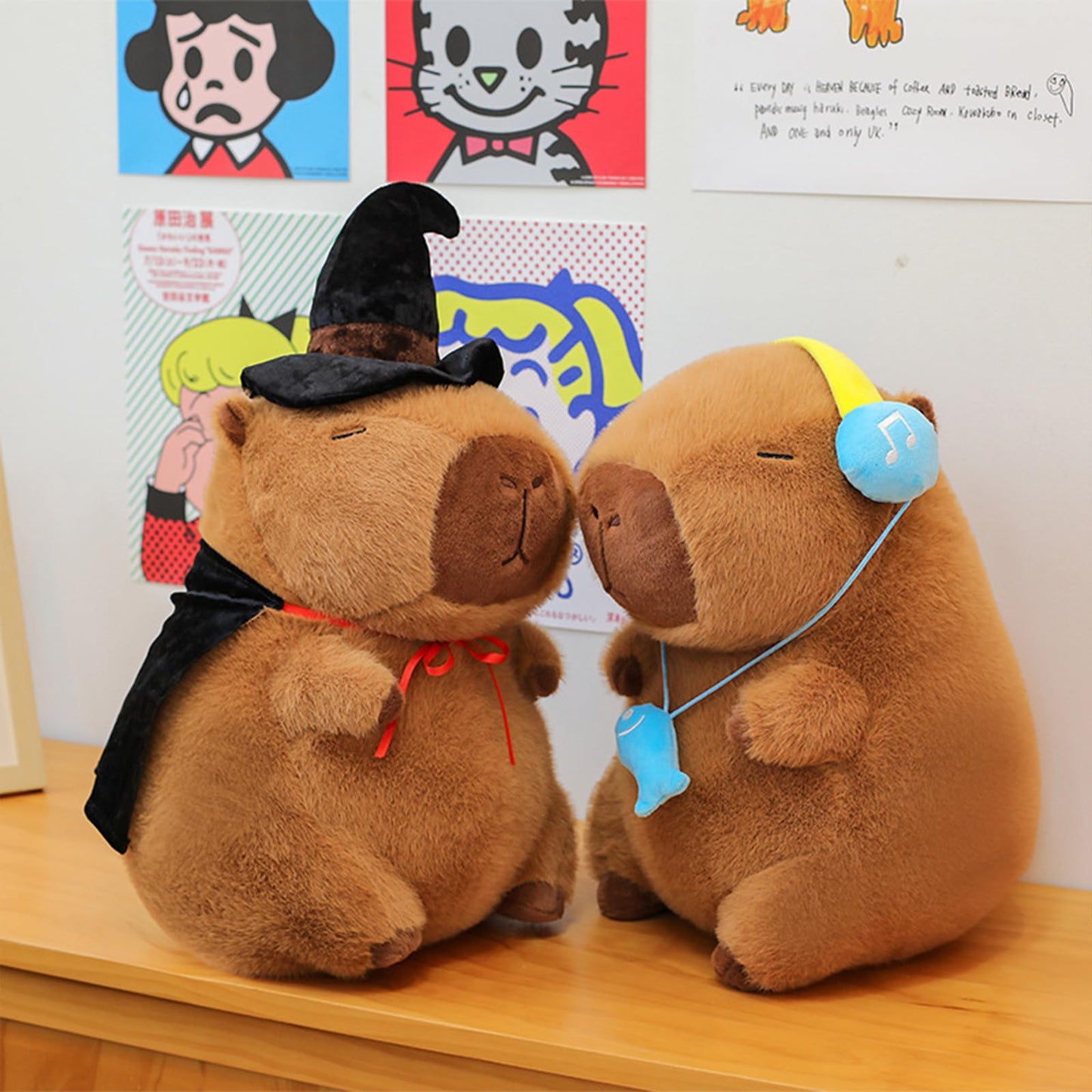 capybara plush with headset and Halloween witch costume sitting on a wooden surface