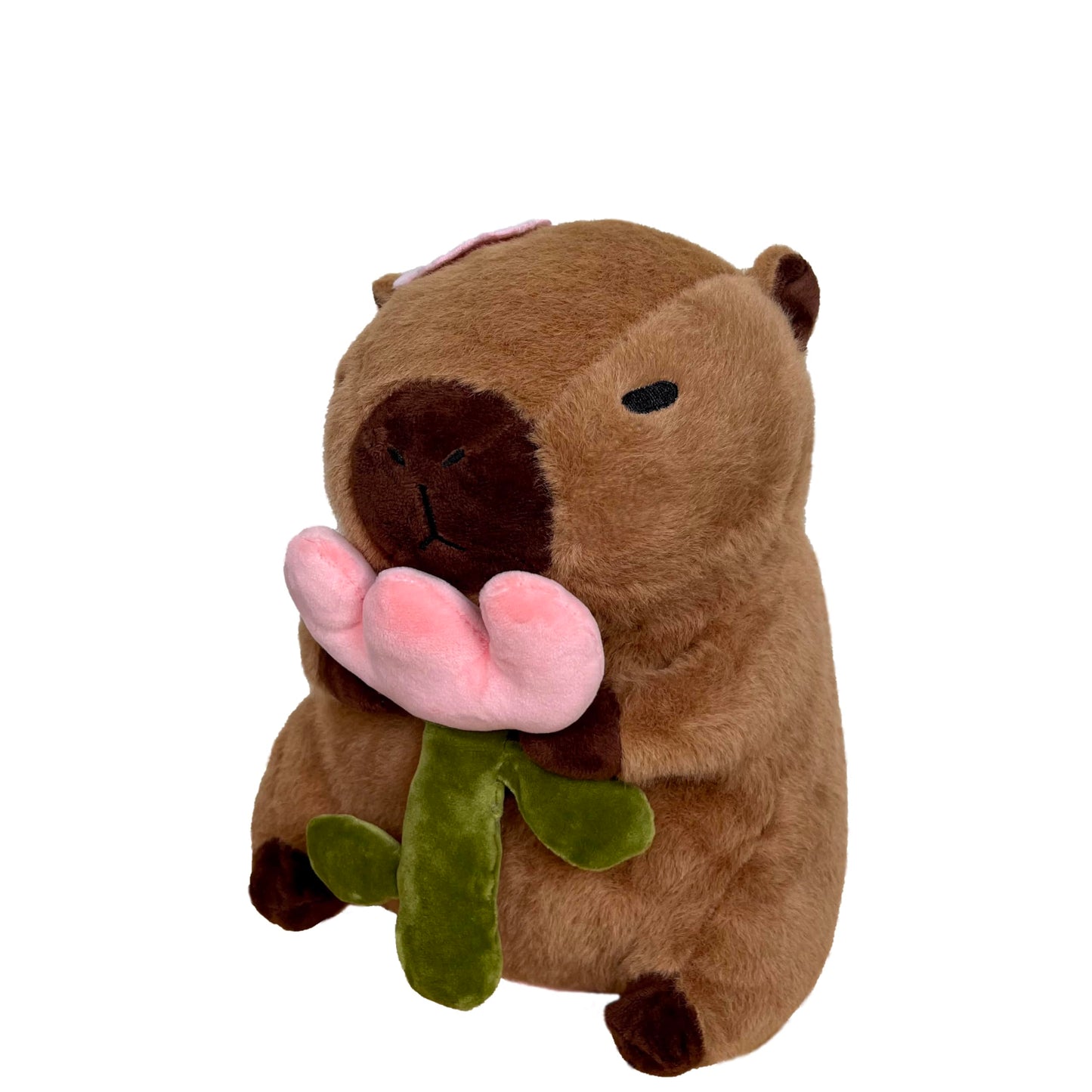 capybara plush with rose holding a pink flower with green stem and leaves