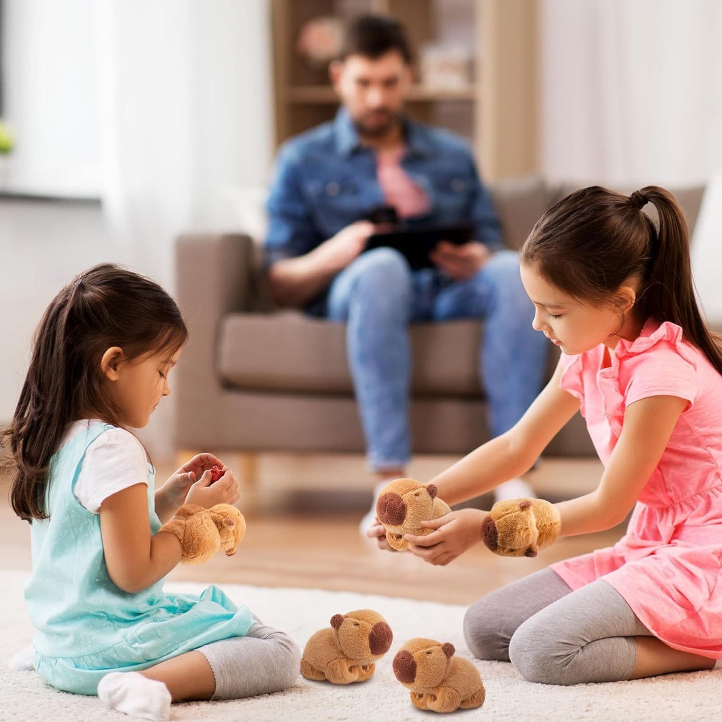 Two young girls playing with Wanwu World capybara slap bracelet plush toys on the floor