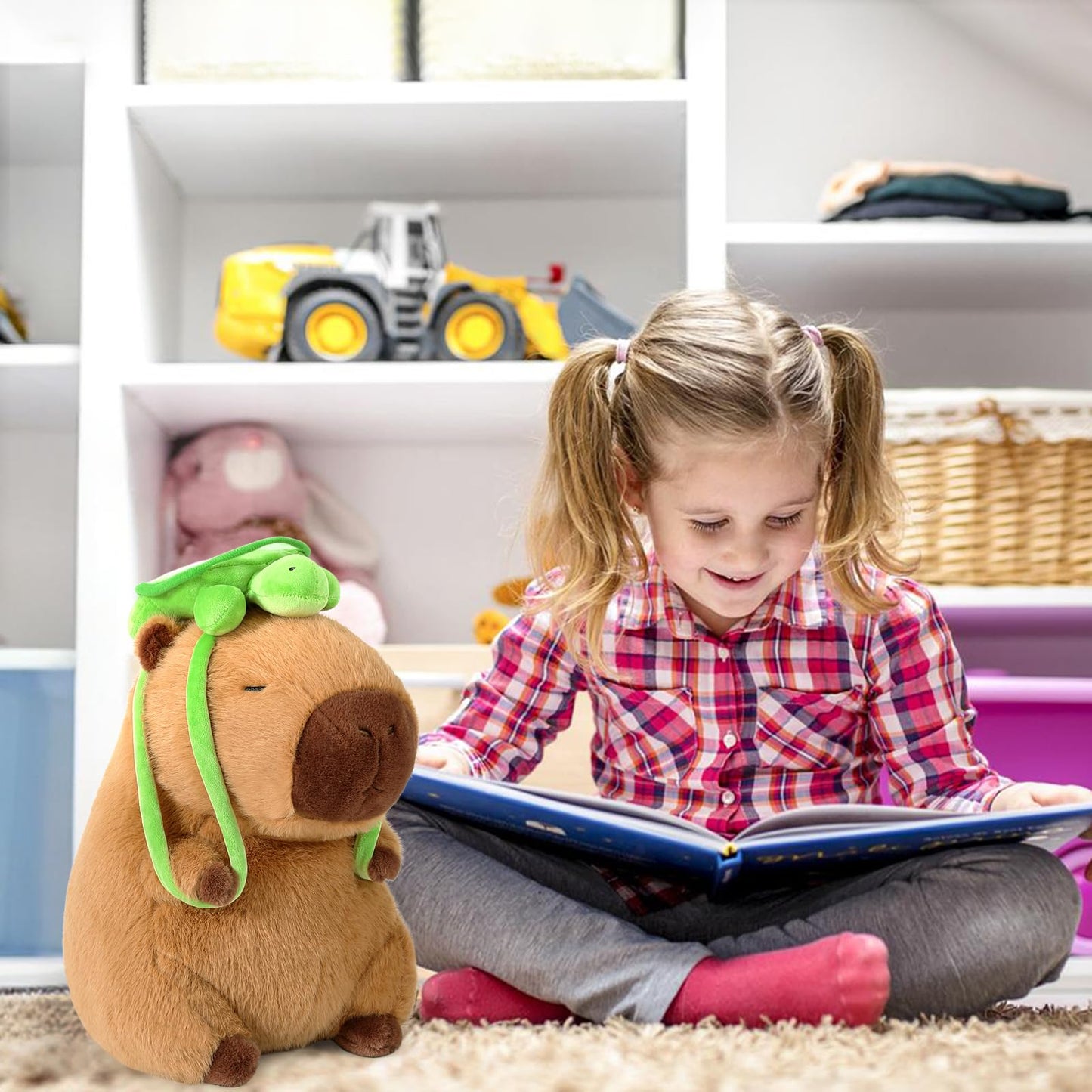 Child reading a book next to a capybara stuffed animal with turtle backpack plush toy