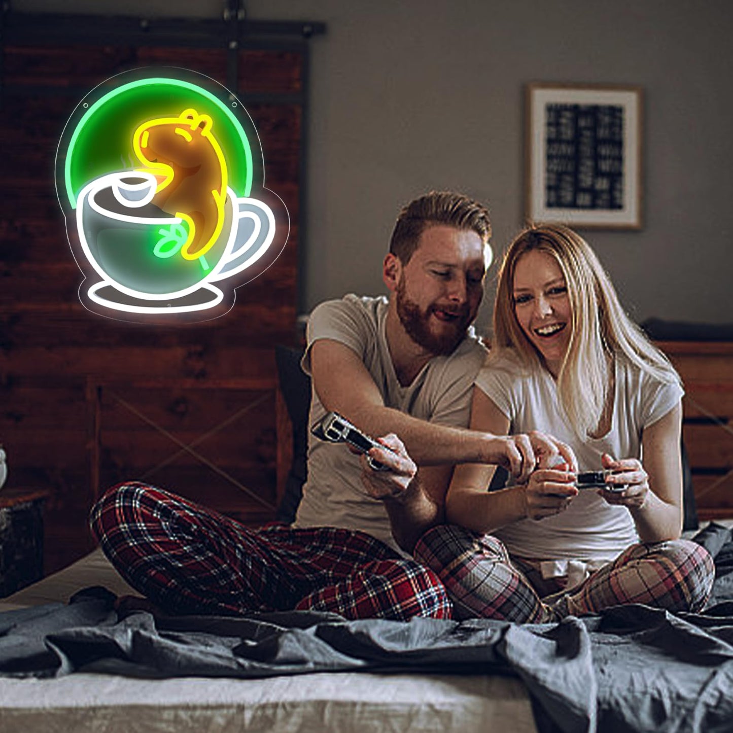 Couple playing video games on bed with WittyRhE cute animal neon wall decor shaped like a yellow animal in a teacup