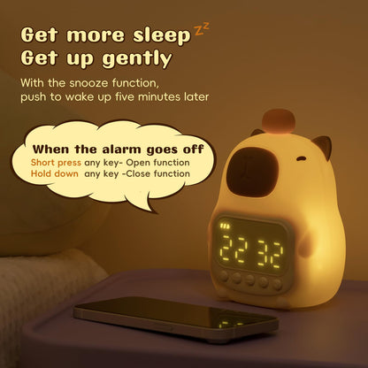 capybara alarm clock with snooze function glowing softly on nightstand beside smartphone