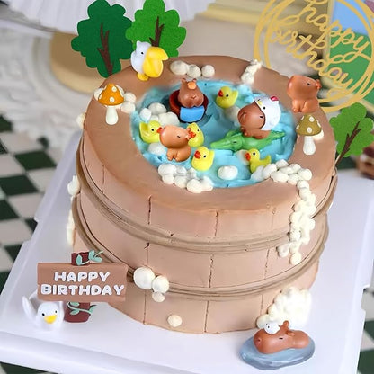 Capybara cake toppers set on a two-tier brown cake with pond and duck decorations