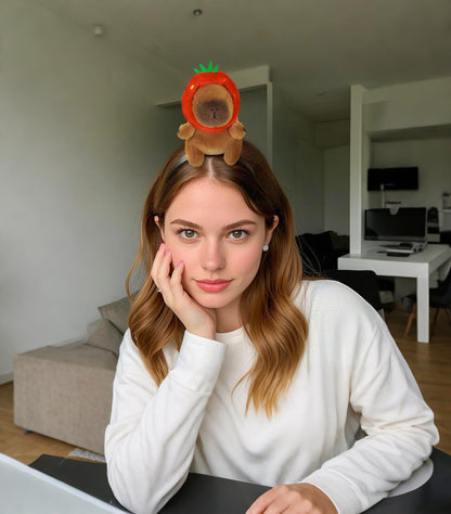Woman wearing capybara headband accessory with plush capybara in a strawberry costume
