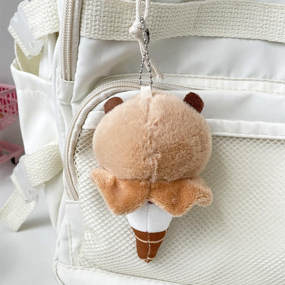 capybara ice cream keychain plush hanging on white backpack with textured pocket