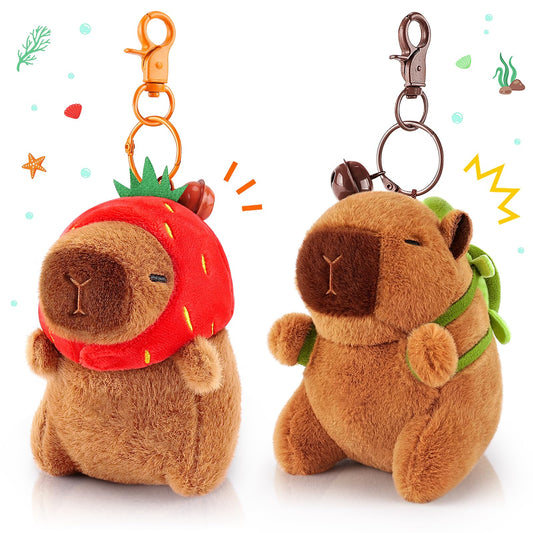 capybara keychain set with two plush keychains one wearing a strawberry hat and the other with a green backpack