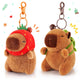 capybara keychain set with two plush keychains one wearing a strawberry hat and the other with a green backpack