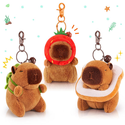 capybara keychain set featuring three plush capybara designs with a strawberry, leaf backpack, and bread costume