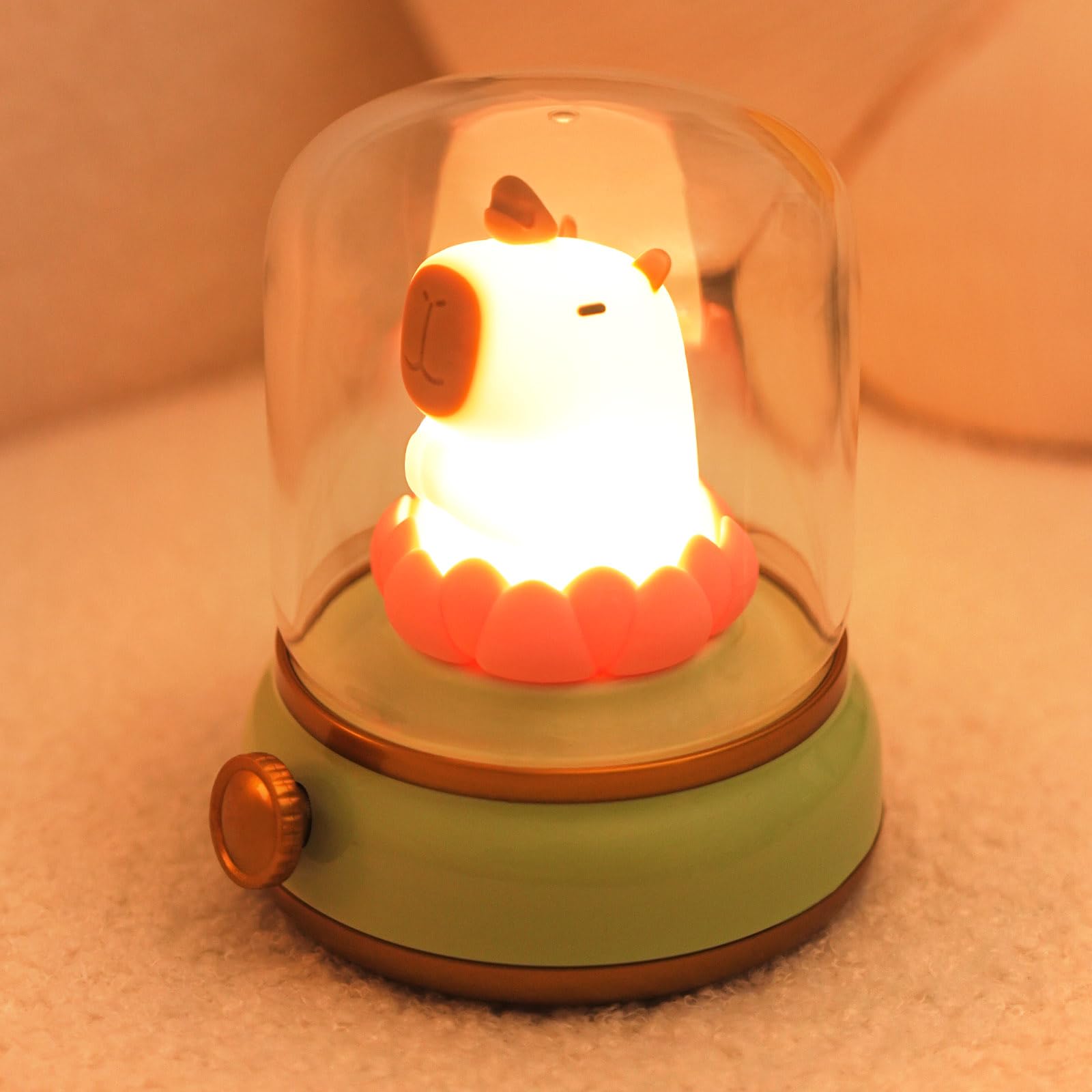 capybara night light with glowing animal figure inside glass dome and green base