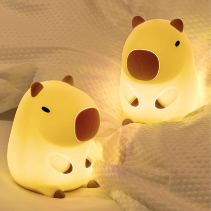 capybara night light glowing softly on a cozy bed for a soothing ambiance