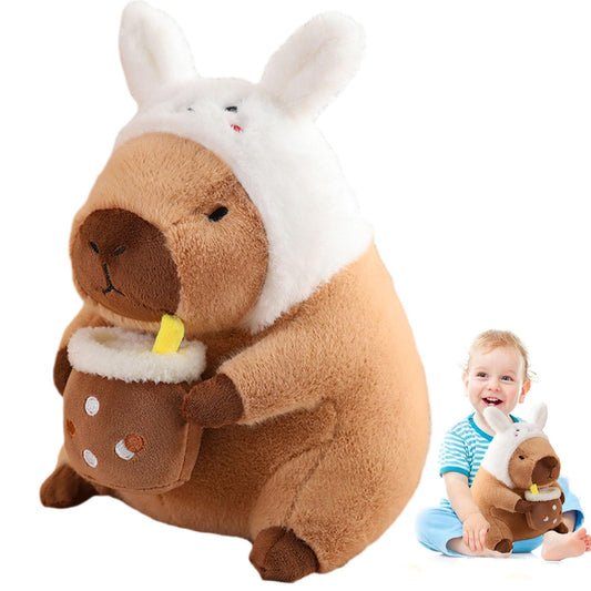 capybara plush toy wearing a white bunny hat holding a cup with a straw next to a smiling toddler